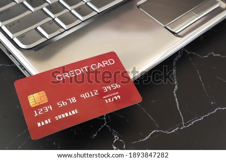 A credit card placed on a laptop computer. Finance concept
