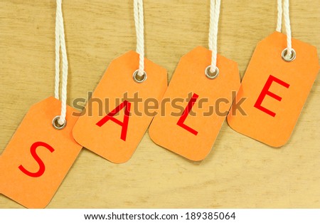 Sale Price tag hanging  with on wooden for background