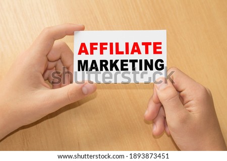 Card with text AFFILIATE MARKETING on handS. You can use in business, marketing and other concepts. Messege of the day.