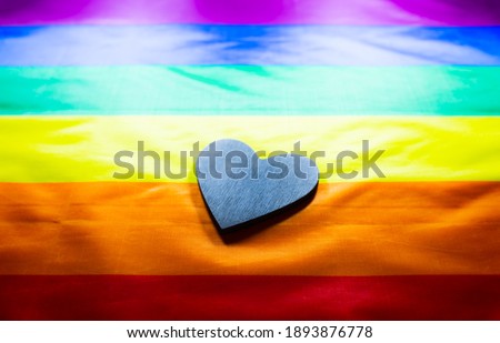 Lgbt community colorful flag. Wooden heart on rainbow background. Lesbian and gay problems. Legalization of marriage for couple with homosexual orientation.