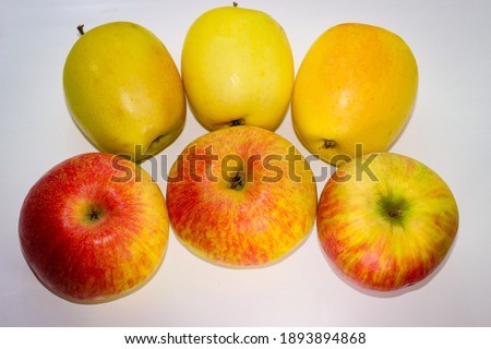 Several apples standing on a white background