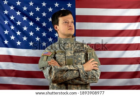 American soldier on the background of the flag. Portrait of a US Army soldier.