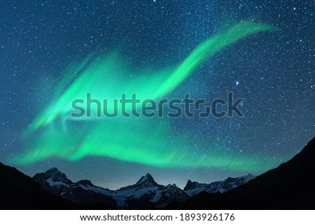 Aurora borealis. Northern lights in winter mountains. Sky with polar lights and stars Royalty-Free Stock Photo #1893926176