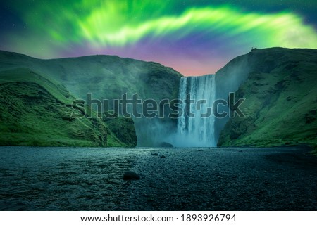 Green aurora light behind famous Skogafoss waterfall on Skoga river. Iceland, Europe. Courtesy of NASA. Photo collage Royalty-Free Stock Photo #1893926794
