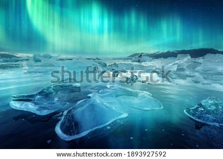 Aurora borealis northen light and icebergs in Jokulsarlon glacial lagoon. Vatnajokull National Park, southeast Iceland, Europe. Landscape photography Royalty-Free Stock Photo #1893927592