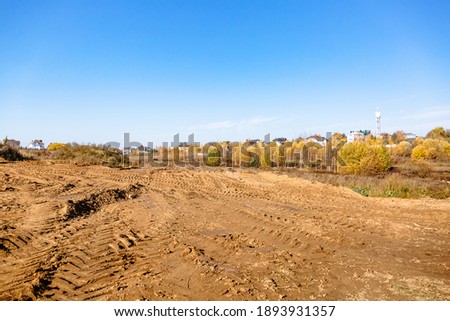 Land reclamation for property development. Sale of land at auction. Commercial building. Leveling, adding soil to the site. Land cleaning work. The first stage of lawn planting. Building area. Banner. Royalty-Free Stock Photo #1893931357