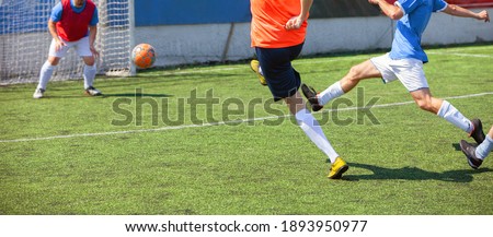 Soccer player kicks the ball on the soccer stadium