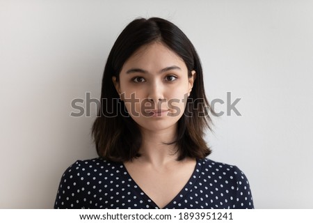 Head shot portrait of millennial beautiful asian korean mixed race woman isolated on white grey studio background, happy young multiracial lady looking at camera, feeling confident, profile photo.
