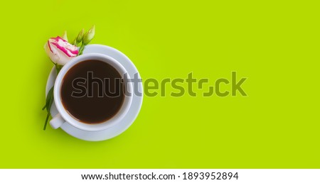  cup of coffee flower rose on a colored background
