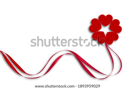 Red ribbons and hearts on white background