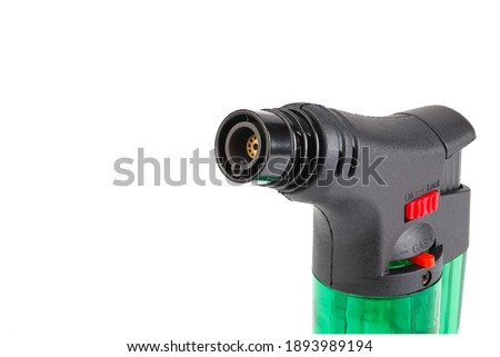 Clear green plastic gas lighter. Gas lighter isolated on white background. Close up gas burner. There is some free space for your text or sign.