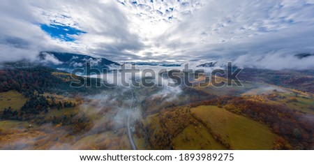 Autumn flight through blue sky in Carpatian autumn mountains, Aerial panoramic drone shot Royalty-Free Stock Photo #1893989275