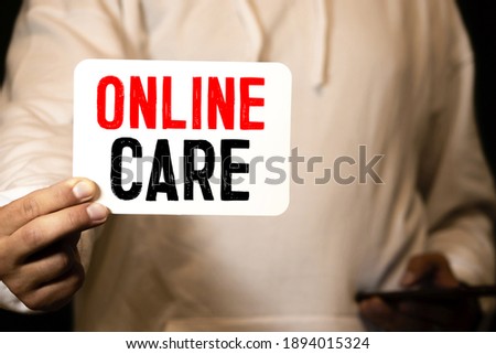 Woman's hands holding black screen mobile phone with text TELEHEALTH and coffee cup in her hand. Concept home care and Telehealth.