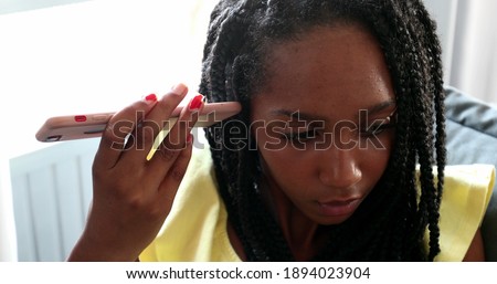 Black girl listening to audio message on smartphone, african teen typing on smartphone
