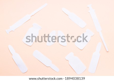lungs symbol and medicaments symbols isolated over pink background. medication concept. syringe,vial,ampoule shapes made paper.