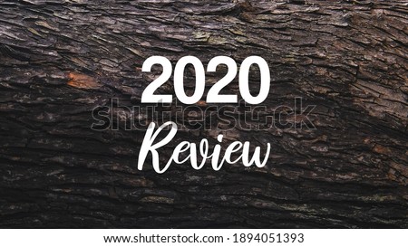 2020 Review incription on mahogany wood background