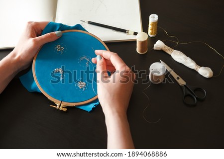 Workplace of an embroiderer with couture embroidery on a hoop Royalty-Free Stock Photo #1894068886
