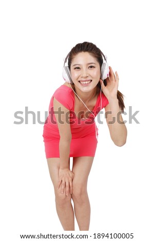 Young woman in pink dress with headset high quality photo