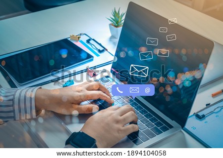 Contact us or Customer support hotline people connect. Businessman using a mobile phone with the (email, call phone, mail) icons. Royalty-Free Stock Photo #1894104058