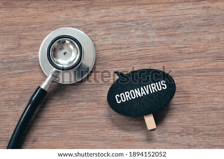 Top view of stethoscope and wooden tag written with text CORONAVIRUS. Health concept. 