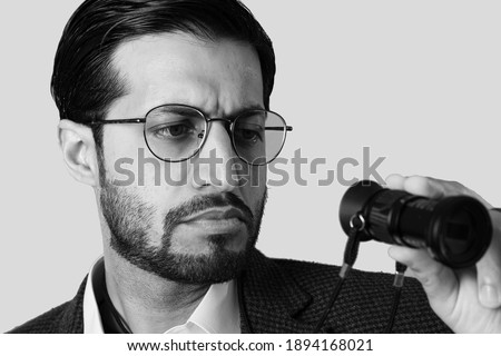 film director looking at directors view finder to check a frame movie director 