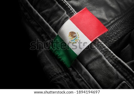 Tag on dark clothing in the form of the flag of the Mexico