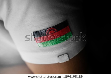 Patch of the national flag of the Malawi on a white t-shirt