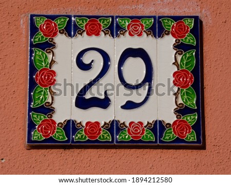 
A sign with the house number twenty-nine - 29