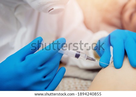 Close-up vaccination inoculation of patient in shoulder, syringe with covid vaccine flu is injected into sick man. Royalty-Free Stock Photo #1894240855