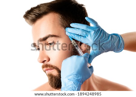 Young and handsome man receiving scalp injection for hair grow Royalty-Free Stock Photo #1894248985