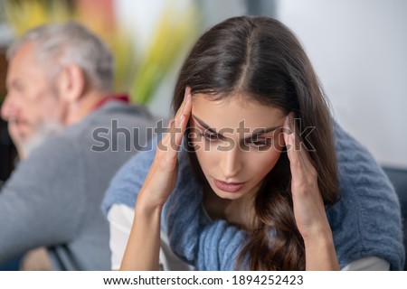 Health and relations. A young woman havinfg a headache as a result of argument Royalty-Free Stock Photo #1894252423