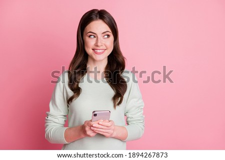 Portrait of pretty curly hairstyle positive person look empty space isolated on pink color background