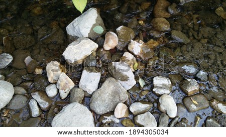 Amazing river stones in different shape and color and water