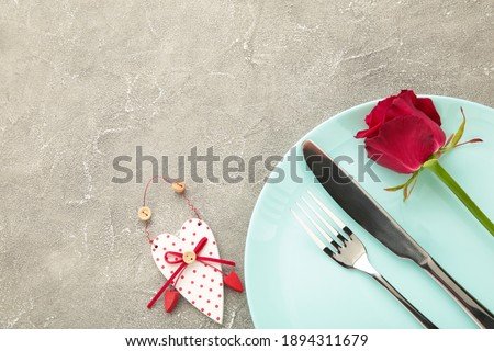Festive table setting for Valentines Day on grey background. Top view