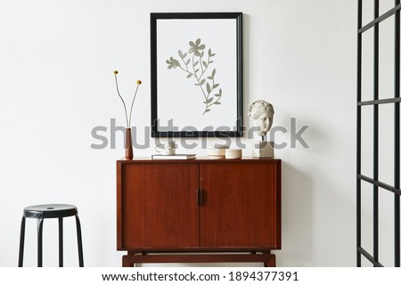 Modern retro concept of living room interior with design teak commode, black mock up poster frame,  dried flower, decoration, white wall and personal accessories. Template.