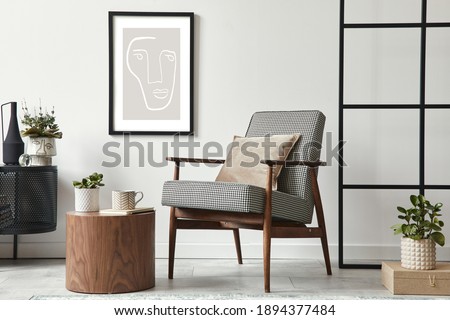 Stylish scandinavian composition of living room with design armchair, black mock up poster frame, commode, wooden stool, book, decoration, loft wall and personal accessories in modern home decor. Royalty-Free Stock Photo #1894377484