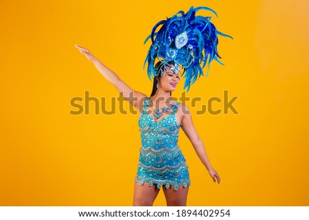 woman posing in samba costume over yellow background with free space 
