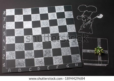 a chessboard on a black background is a cook and a painted gift. Space for advertising