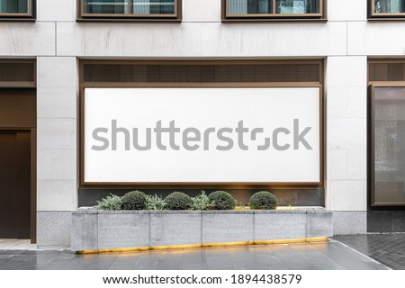 Blank billboard sign mockup in the urban environment, on the facade, empty space to display your advertising or branding campaign Royalty-Free Stock Photo #1894438579