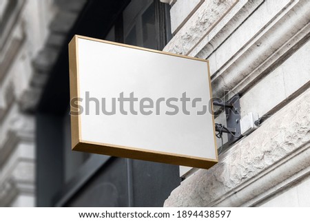 Blank sign mockup in the urban environment, on the facade, empty space to display your store sign or logo