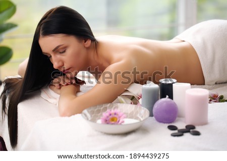Beautiful european girl resting relaxing in spa resort with closed eyes.