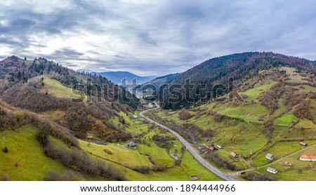 Sky with white and fluffy layer of clouds over green autumn hills, Aerial panoramic  shot