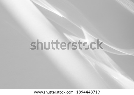 Blurred water texture overlay effect for photo and mockups. Organic drop diagonal shadow and light caustic effect on a white wall. Shadows for natural light effects Royalty-Free Stock Photo #1894448719