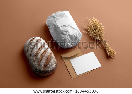 Bakery branding mockup, wrapped in paper bread, wheat, empty space to display your logo or design.