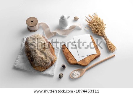 Blank cards on the serving board with bread, bakery branding mockup, empty space to display your logo or design.
