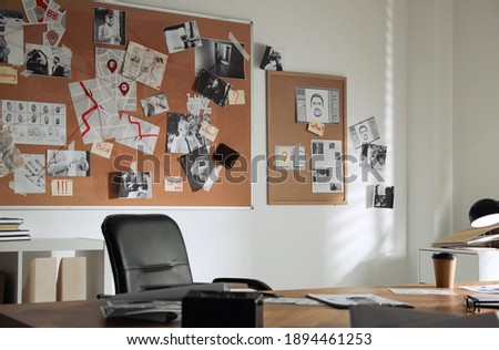 Detective office interior with big wooden desk and evidence board