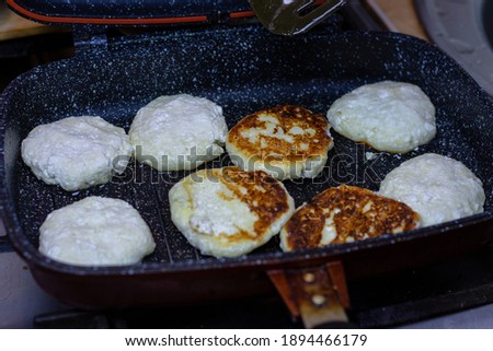 Fry cheese cakes at home in a pan