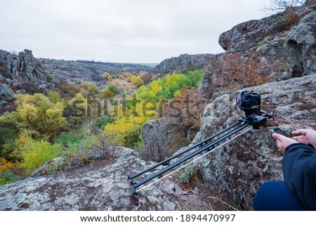 Camera on slider shots footage of beautiful hills covered with autumn trees in the Carpathians mountains