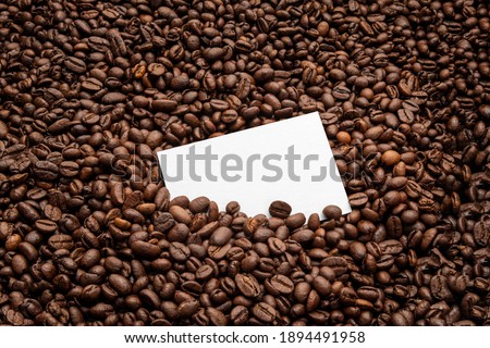 Blank business card mockup on coffee seeds background,  coffee packaging mockup with empty space to display your branding design.