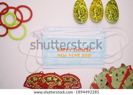 A picture of face mask written Happy Chinese New Year and Chinese's 2021 decoration. World celebrating Chinese New Year with pandemic.